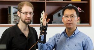 Otto Seyfarth and Lei Cui from Curtin university with the finger exoskeleton. Photograph — Matt Devlin.