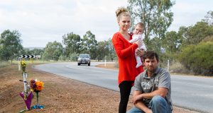 Adam, Lotti and Emilia Fairey at the S-bend outside their property, which has been the scene of three major crashes in six months. Photograph — Matt Devlin.