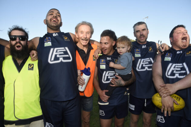 Footy player celebrating a win together.