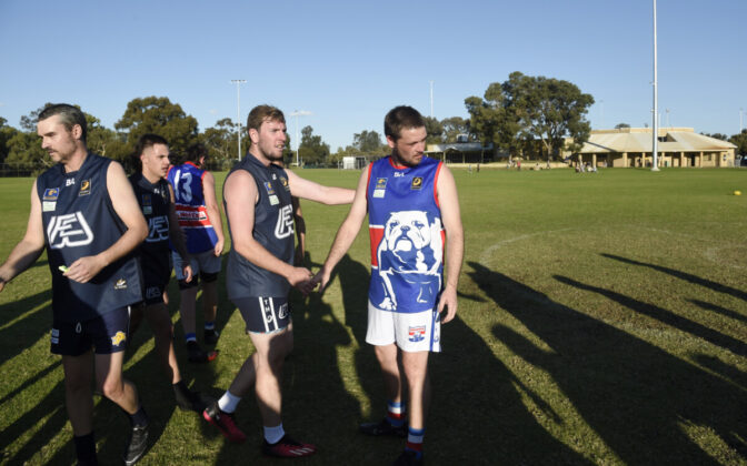 Opposition players shaking hands.