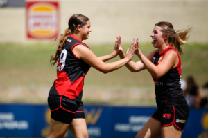 Perth Demon's Rogers Cup players high five after a goal.