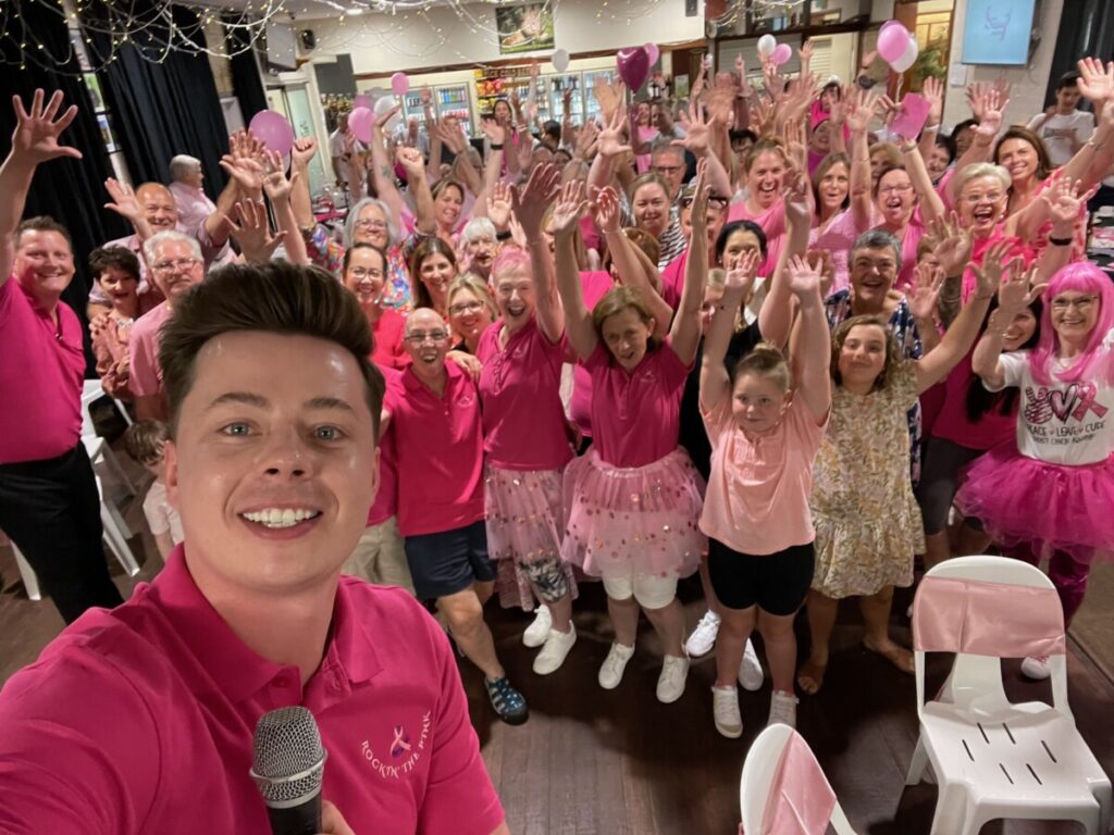 Big group photo of people wearing pink. 