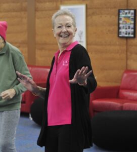 Women wearing pink dancing.