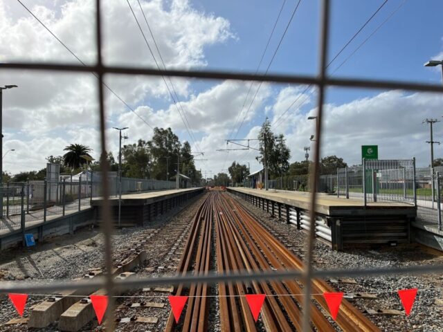 A train station behind a fence