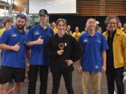 Students pose with trophy.