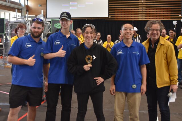 Students pose with trophy.