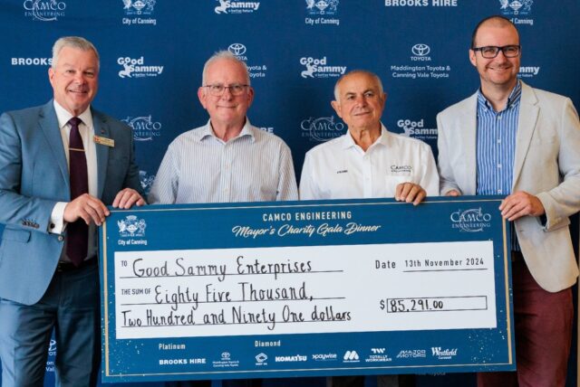 Staff holding a big cheque.